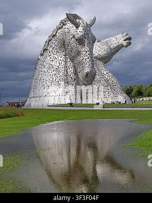 Les Kelpies par un temps dramatique à The Helix, Falkirk, avec un reflet de l'eau mettant en valeur les célèbres sculptures équestres écossaises., FK2 7ZT Banque D'Images