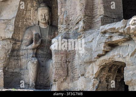 Vue de la grande statue de Bouddha sculptée des grottes de Yungang, présentant des sculptures sur pierre complexes et de petites figures sur les parois rocheuses environnantes Banque D'Images