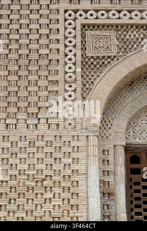 Détail de maçonnerie en briques ornées du mausolée Ismail Samani à Boukhara montrant des motifs géométriques complexes et un arc. Idéal pour les études architecturales, heri Banque D'Images