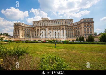Façade avant du Palais du Parlement avec une large pelouse verte à Bucarest, Roumanie Banque D'Images