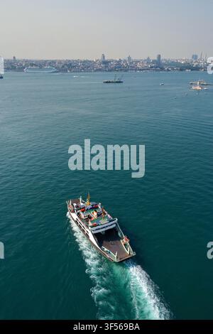 Vue aérienne d'un ferry traversant le Bosphore près du quartier du Harem avec la ligne d'horizon d'Istanbul en arrière-plan, Uskudar, Istanbul, Turquie. Banque D'Images