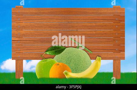Un modèle de panneau en bois vide décoré de fruits variés comprenant du melon, une pomme verte, une orange et une banane sur une pelouse verte vibrante sous un ciel clair Banque D'Images