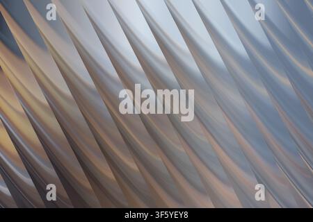 Un fond abstrait sophistiqué avec des vagues métalliques diagonales répétitives, présentant un éclairage doux et des dégradés fluides qui créent une atmosphère industrielle élégante Banque D'Images