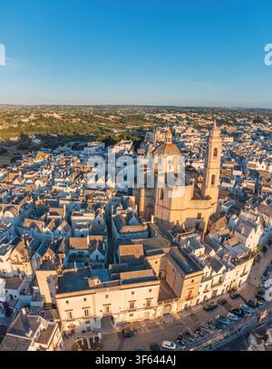Vue aérienne de la Chiesa Madre di San Giorgio Martire et du centre historique de Locorotondo à l'heure dorée, Locorotondo, province de Bari, Valle d'Itria, Pouilles, Italie Banque D'Images