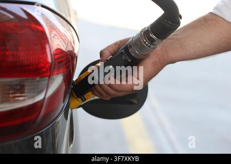 Homme faisant le plein de sa voiture avec une pompe à diesel à la station-service, gros plan Banque D'Images