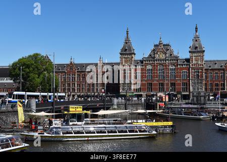 Amsterdam, Pays-Bas – 19 mai 2025 : bateaux de tourisme devant la gare d’Amsterdam Centraal à Amsterdam, Pays-Bas Banque D'Images
