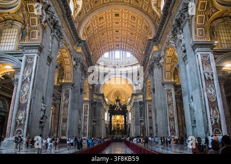 Cité du Vatican, Vatican - 10 août 2019 : Des foules de touristes remplissent la nef à l'intérieur de la basilique Saint-Pierre. Banque D'Images