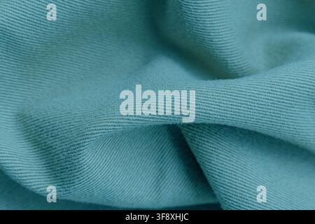 Texture macro de tissu en coton tricoté vert menthe avec des plis et des ondulations douces, fond détaillé pour l'industrie de la mode, espace de copie photo stock. Banque D'Images