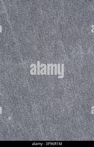 Fond en tissu denim gris. Gros plan de la texture textile tissée du jean. Matériau en coton résistant pour la fabrication de vêtements. Motif de surface abstrait pour Banque D'Images
