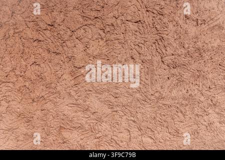 Mur en plâtre de terre cuite rugueux avec une texture de surface inégale appliquée à la main Banque D'Images