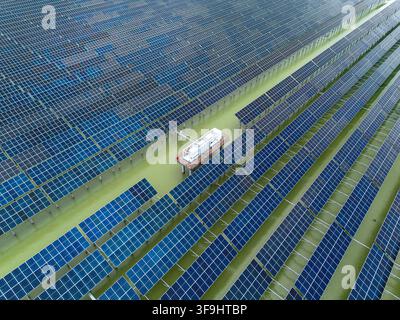 Vue aérienne du parc solaire de Sirajganj de 68 MW avec des rangées de panneaux solaires installés sur l'eau, comprenant une plateforme de maintenance centrale à Sirajganj, Rajsha Banque D'Images