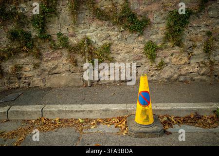 Août 2026 - Cônes de stationnement jaunes sur une rue à Cheddar, Somerset, Angleterre, Royaume-Uni. Banque D'Images