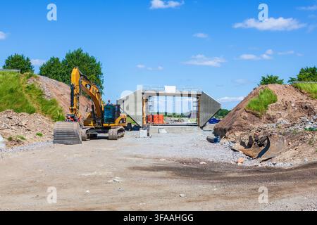 Construction routière avec une pelleteuse Banque D'Images