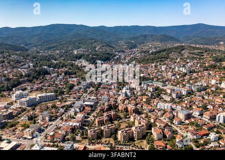 Panorama aérien par drone de Vrnjačka Banja, Serbie, photographié le 15 août 2026. L'image montre la ville thermale entourée de collines boisées et de verts pré Banque D'Images