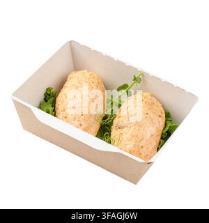 Côtelettes de poulet cuites à la vapeur dans une boîte à repas isolée Banque D'Images