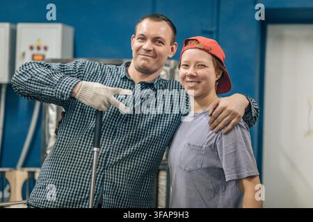 Collègues amicaux posant ensemble dans leur atelier Banque D'Images