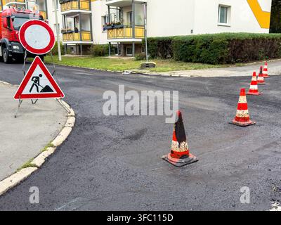 Surface d'asphalte noir fraîche sur une route urbaine rénovée – Chantier de construction Banque D'Images