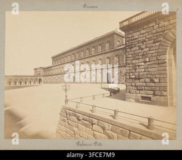 Vue du côté jardin du Palazzo Pitti à Florence, photographie, inscription : 'Firenze, Palazzo Pitti', photographe : attribué aux Fratelli Alinari, Florence, c. 1865 - c. 1900, Toscane, Attribué à, papier, carton, impression à l’albumine, calligraphie, hauteur 427 mm x largeur 559 mm, hauteur 535 mm x largeur 722 mm, Palazzo Pitti., Une photographie sépia d’un grand bâtiment en pierre avec une façade texturée et des rangées de fenêtres en arc, une longue arcade en colonnade s’étendant d’un côté, une cour pavée devant, une balustrade en pierre basse et une passerelle en bois le long du bord de la cour, des lampadaires ornés Banque D'Images