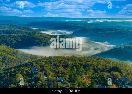 Photographie aérienne de la brume et du brouillard dans la vallée près de la ville de Woodford dans les Blue Mountains en Nouvelle-Galles du Sud, Australie Banque D'Images