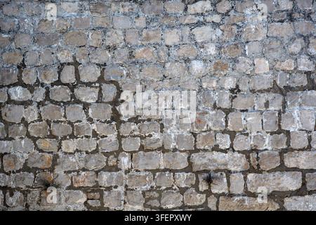 Ancien mur en pierre médiéval à utiliser comme texture de fond Banque D'Images