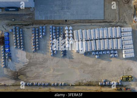 Vue aérienne du terminal d'importation de ciment CEMEX de Pensacola présentant des rangées de silos de stockage blancs et des palettes recouvertes de bleu sur un site industriel à Pens Banque D'Images