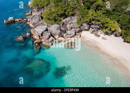 Vue aérienne de Nudey Beach sur Fitzroy Island avec une eau turquoise, un sable blanc et de gros rochers de granit entourés d'une forêt tropicale luxuriante sur Fitzro Banque D'Images