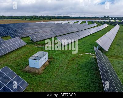 Vue aérienne par drone d'une grande ferme solaire avec panneaux photovoltaïques et infrastructure électrique Banque D'Images