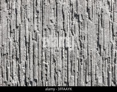 Texture murale en béton rainuré vertical décoratif, fond en relief de stuc linéaire gris pour un design architectural moderne avec espace de copie Banque D'Images
