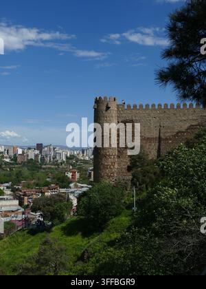 GÉORGIE, CAUCASE - 27 AVRIL 2024 - Murs de pierre de la forteresse de Narikala sur une colline avec une vue panoramique imprenable sur la vieille ville de Tbilissi, sa ligne d'horizon et la rivière bel Banque D'Images