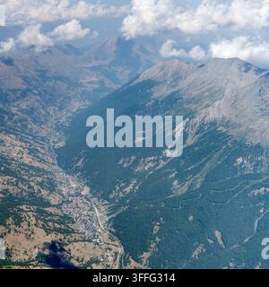 Paysage aérien avec vue sur la vallée de Chisone et le village touristique de Pragelato depuis le sud, pris depuis un planeur dans une lumière estivale lumineuse, Italie Banque D'Images