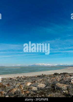 Rocky Shoreline et montagnes enneigées au parc d'État d'Antelope Island. Banque D'Images