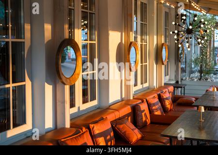 Intérieur de la terrasse extérieure du restaurant avec des canapés confortables et des tables pour observer le coucher du soleil. Banque D'Images