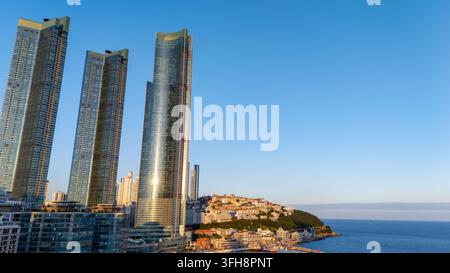 Immeubles de grande hauteur de Busan Haeundae le long de la côte, mettant en valeur une architecture moderne et une vue imprenable sur l'océan sous un ciel dégagé Banque D'Images