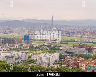 Taipei 101 s’élève au-dessus de l’agglomération urbaine sur un fond de montagnes brumeuses. Banque D'Images