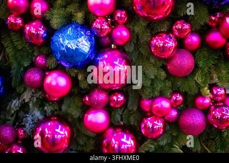 Arbre avec de nombreuses décorations de Noël roses et bleues Banque D'Images