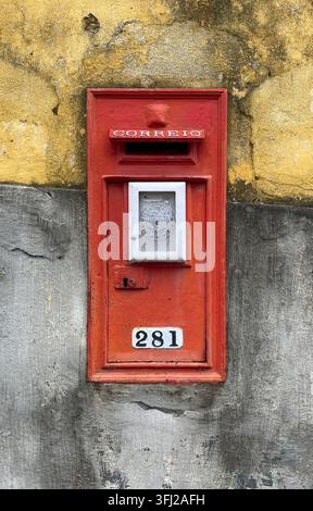 Caisse postale CORREIO rouge numéro 281 sur un mur érodé, Portugal, nostalgie postale vintage Banque D'Images