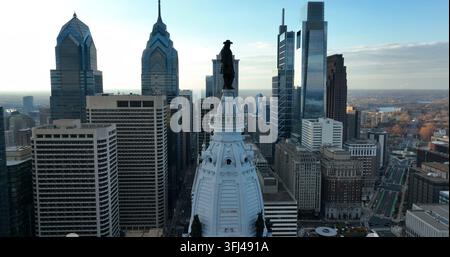 Une montée aérienne révèle une statue au sommet de l’hôtel de ville. Skyline de Philadelphie et immeubles de grande hauteur en forme de gratte-ciel, Pennsylvanie. Banque D'Images