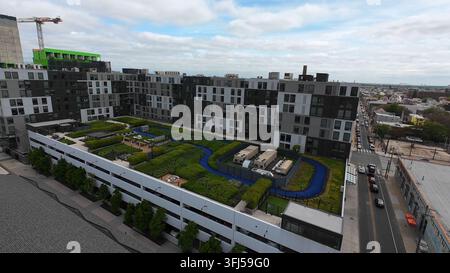Plan d’établissement aérien d’un immeuble d’appartements moderne dans une ville américaine avec toit vert, parc pour chiens. Prise de vue par drone FPV, Philadelphie, Pennsylvanie. Banque D'Images