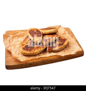 Côtelettes de poulet frit sur papier sulfurisé Banque D'Images