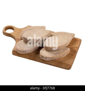 Côtelettes de poulet crues sur planche en bois Banque D'Images