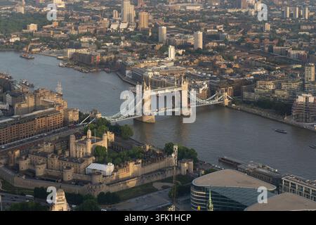 Une vue aérienne capture le Tower Bridge et la Tour de Londres au-dessus de la Tamise pour mettre en valeur ces monuments historiques emblématiques. Banque D'Images