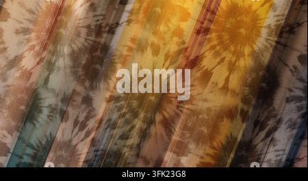 Un fond en tissu texturé présentant un motif coloré de rayons de soleil tie-dye surimprimé de rayures diagonales dans divers tons chauds et froids. Banque D'Images