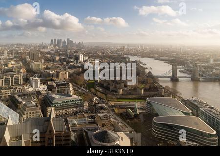 Une vue aérienne depuis la ville de Londres montrant la Tour historique de Londres, Tower Bridge et les gratte-ciel lointains de Canary Wharf. Banque D'Images