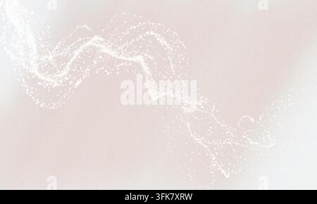 Une traînée gracieuse et fluide de particules blanc vif se déplaçant sur un fond doux et clair, créant un effet visuel élégant et éthéré. Banque D'Images