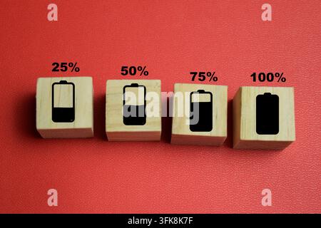 Indicateur de niveau de charge de la batterie avec des cubes en bois empilés numérotés sur la table. Pour l'état d'énergie et la capacité de puissance Banque D'Images