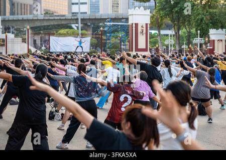 Les habitants font de l'exercice en plein air sur la place du parc Lumpini à Bangkok lors d'un entraînement de groupe gratuit. Banque D'Images