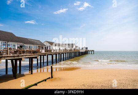 La jetée de Southwold s'étendant sur la mer du Nord depuis une plage de sable doré dans le Suffolk, en Angleterre, sous un ciel d'été bleu éclatant. Banque D'Images