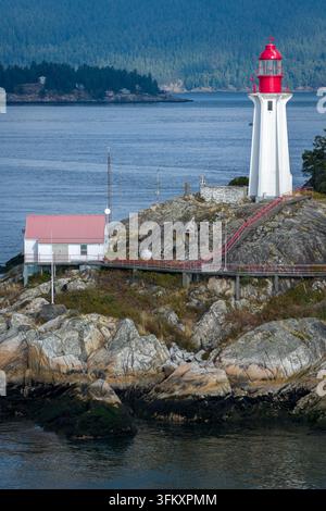 Vue aérienne du Lighthouse Park avec son phare emblématique, sa côte rocheuse, son bâtiment au toit rouge et sa passerelle métallique à West Vancouver, Colombie-Britannique Banque D'Images