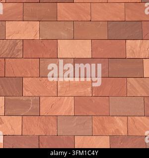 Gros plan abstrait plein écran d'un mur de briques rectangulaires brunes, de couleur terre cuite et rougeâtre, mettant en valeur leurs textures et teintes variées dans un pr Banque D'Images