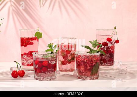 Eau détox avec framboises, cerises et groseilles sur glace. Un cocktail de limonade maison rafraîchissant d'été. Jus de fruits et ingrédients, perte de poids Banque D'Images